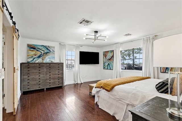 212 Ranger Pl, Slidell, LA 70458 - bedroom featuring multiple windows, a chandelier, a barn door, and wood-type flooring