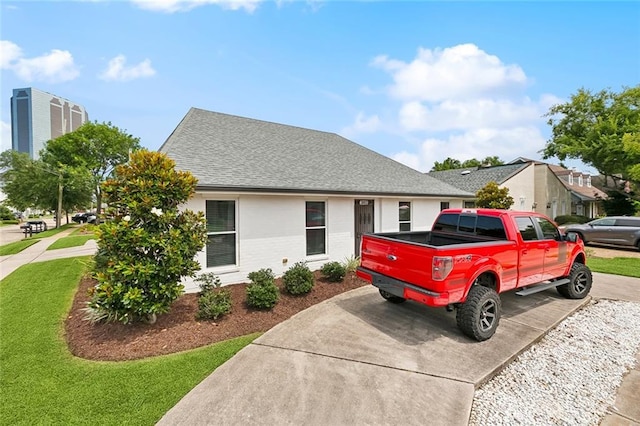 3813 N Arnoult Rd, Metairie, LA 70002 - view of front of home with concrete driveway, a shingled roof, brick siding, and a front lawn