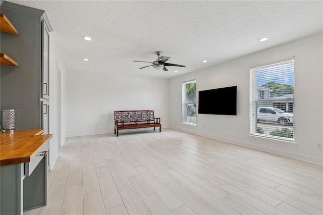 3813 N Arnoult Rd, Metairie, LA 70002 - living area featuring light wood-style floors, a textured ceiling, ceiling fan, and recessed lighting
