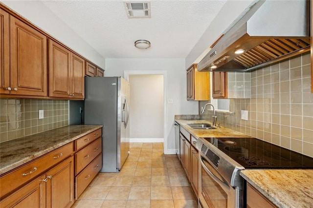3813 N Arnoult Rd, Metairie, LA 70002 - kitchen featuring appliances with stainless steel finishes, custom range hood, brown cabinetry, backsplash, and a textured ceiling