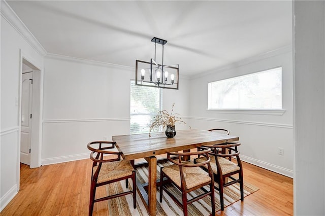 4043 S Inwood Ave, New Orleans, LA 70131 - dining room with crown molding, light wood-style flooring, and a chandelier