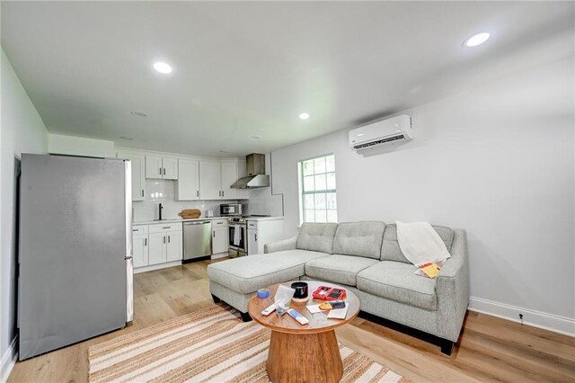 4043 S Inwood Ave, New Orleans, LA 70131 - living area with a wall unit AC, light wood-style floors, and recessed lighting