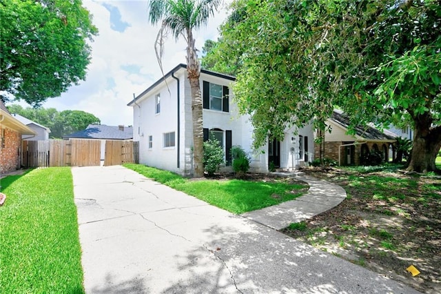 4043 S Inwood Ave, New Orleans, LA 70131 - view of front facade with concrete driveway, a gate, and stucco siding