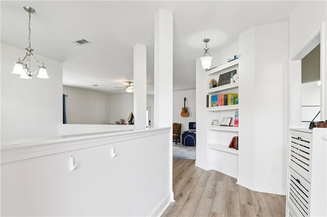 5233 Savannah Ln, Marrero, LA 70072 - corridor featuring light wood finished floors and a chandelier