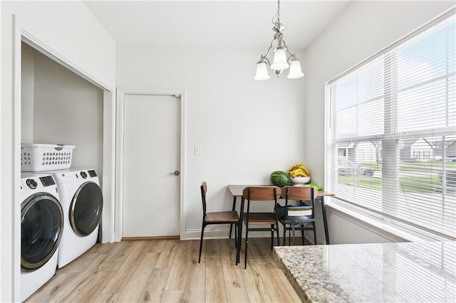 5233 Savannah Ln, Marrero, LA 70072 - washroom featuring washer and dryer, light wood-style floors, and a chandelier