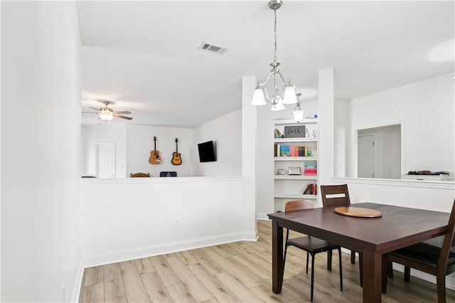 5233 Savannah Ln, Marrero, LA 70072 - dining area with a chandelier, wood finished floors, and a ceiling fan