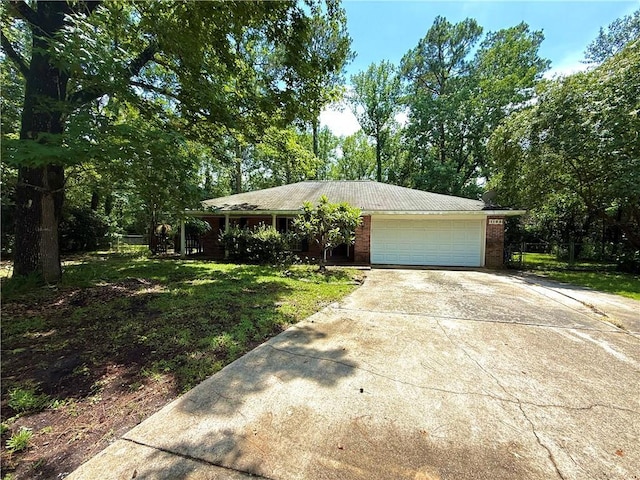 1103 Maine Ave, Slidell, LA 70458 - view of front facade with driveway, an attached garage, brick siding, and a front yard