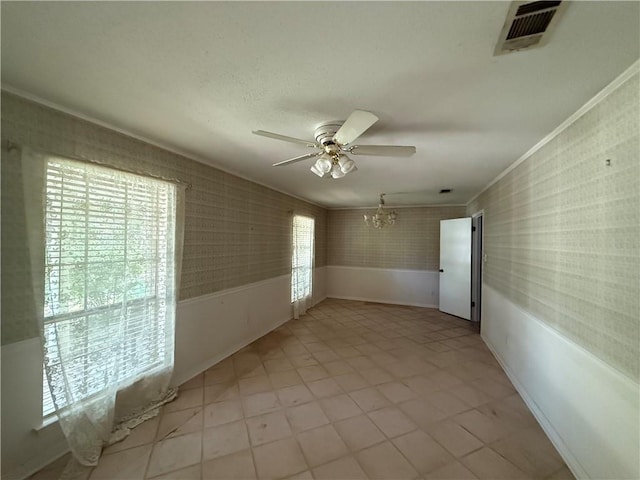 1103 Maine Ave, Slidell, LA 70458 - unfurnished room featuring a ceiling fan, a chandelier, crown molding, wallpapered walls, and light tile patterned flooring