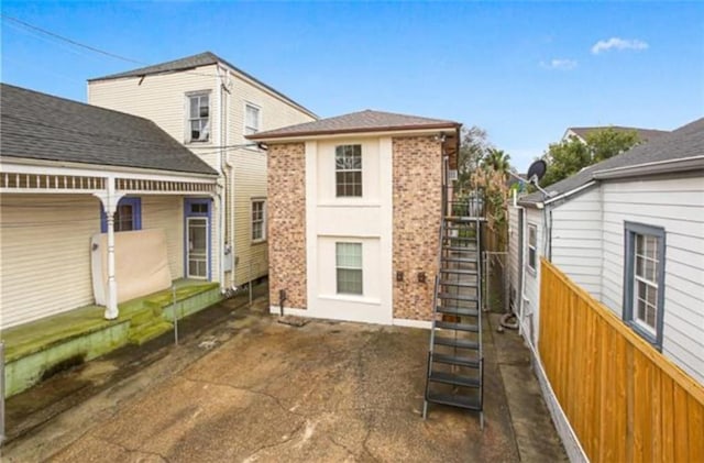 616-61818 Jena St, New Orleans, LA 70115 - rear view of house with brick siding and stairs
