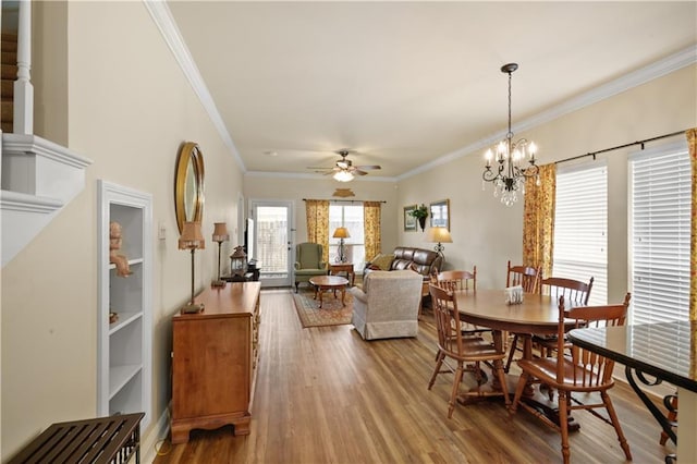 158 Emerald Oaks Dr, Covington, LA 70433 - dining room featuring a ceiling fan, wood finished floors, ornamental molding, and a chandelier