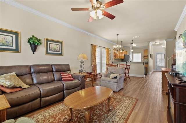 158 Emerald Oaks Dr, Covington, LA 70433 - living room featuring a chandelier, crown molding, a ceiling fan, and light wood-type flooring