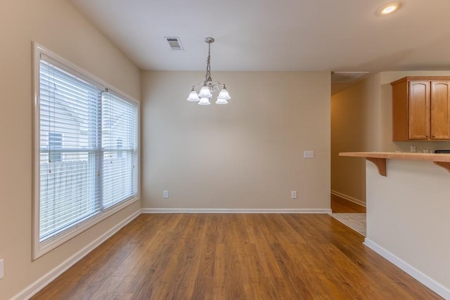 416 Juliette Ln, Mandeville, LA 70448 - empty room featuring wood finished floors and a chandelier