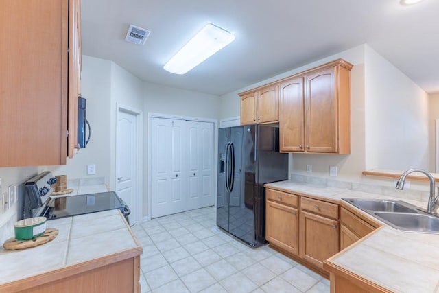 416 Juliette Ln, Mandeville, LA 70448 - kitchen featuring black appliances, light tile patterned flooring, and tile counters