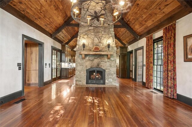 266 Wpa Rd, Ms, MS 39459 - unfurnished living room with hardwood / wood-style floors, a chandelier, a wood ceiling with exposed beams, a stone fireplace, and high vaulted ceiling