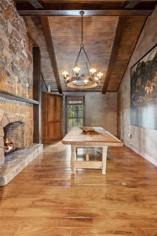 266 Wpa Rd, Ms, MS 39459 - unfurnished dining area with wooden ceiling, light wood finished floors, a chandelier, and a fireplace