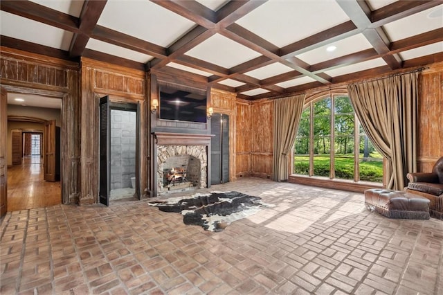 266 Wpa Rd, Ms, MS 39459 - unfurnished living room featuring wooden walls, a lit fireplace, beam ceiling, coffered ceiling, and recessed lighting