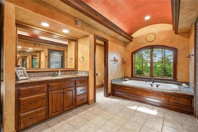 266 Wpa Rd, Ms, MS 39459 - bathroom with lofted ceiling, vanity, a bath, tile patterned flooring, and recessed lighting