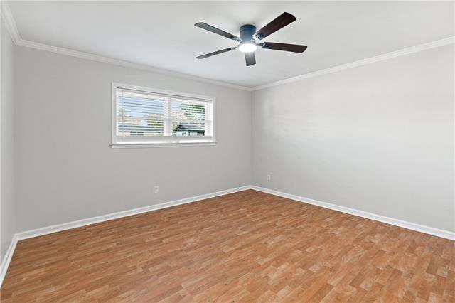 1139 Nursery Ave, Metairie, LA 70005 - unfurnished room with light wood-type flooring, ornamental molding, and a ceiling fan