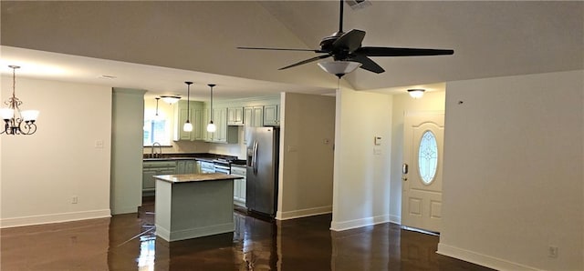 2641 Long Branch Dr, Marrero, LA 70072 - kitchen with stainless steel fridge with ice dispenser, a ceiling fan, hanging light fixtures, a chandelier, and a kitchen island