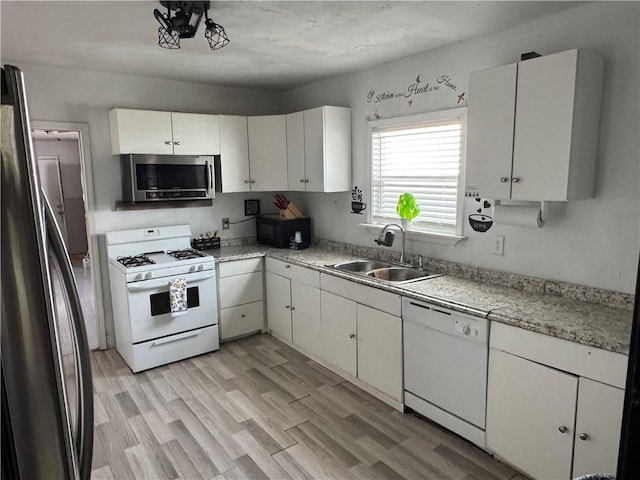 2903 Arlington St, Jefferson, LA 70121 - kitchen with stainless steel appliances, light countertops, light wood-type flooring, and white cabinetry