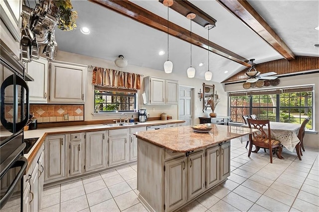201 Milbank Ln, Pearl River, LA 70452 - kitchen featuring light tile patterned floors, a center island, black appliances, a ceiling fan, and decorative backsplash