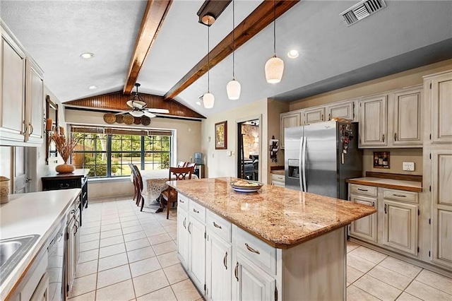 201 Milbank Ln, Pearl River, LA 70452 - kitchen featuring stainless steel appliances, light tile patterned floors, a center island, pendant lighting, and cream cabinetry