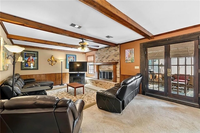 201 Milbank Ln, Pearl River, LA 70452 - living room with carpet floors, a wainscoted wall, a ceiling fan, a brick fireplace, and beamed ceiling