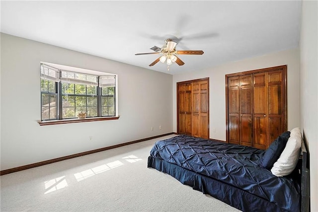 201 Milbank Ln, Pearl River, LA 70452 - bedroom featuring two closets, carpet flooring, and a ceiling fan