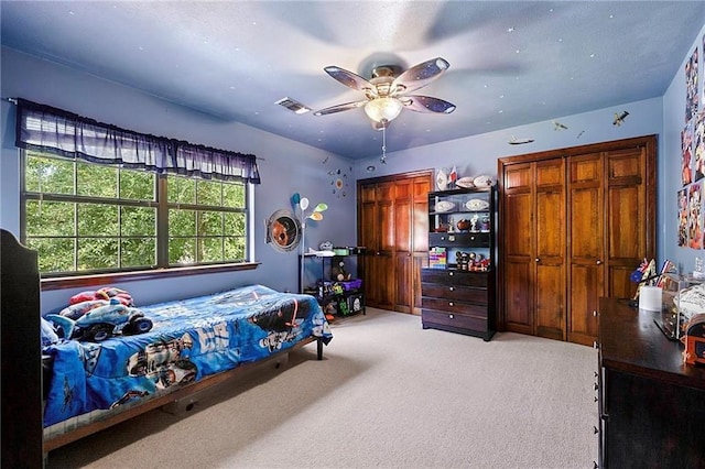 201 Milbank Ln, Pearl River, LA 70452 - bedroom featuring light carpet, ceiling fan, and two closets