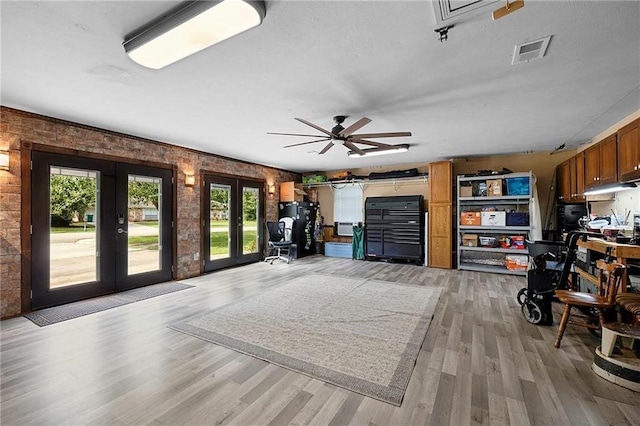201 Milbank Ln, Pearl River, LA 70452 - living area with french doors, light wood-style floors, brick wall, and ceiling fan