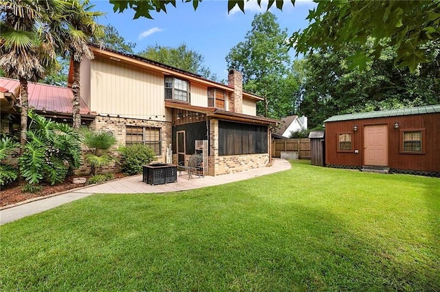 201 Milbank Ln, Pearl River, LA 70452 - rear view of house featuring a chimney, a patio area, brick siding, and a sunroom
