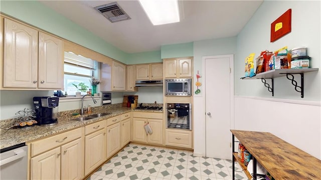 1128 N Upland Ave, Metairie, LA 70003 - kitchen featuring stainless steel appliances, under cabinet range hood, light stone counters, and light floors