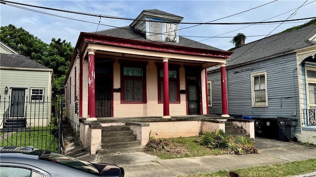 123537 Alvar St, New Orleans, LA 70117 - shotgun-style home featuring a porch