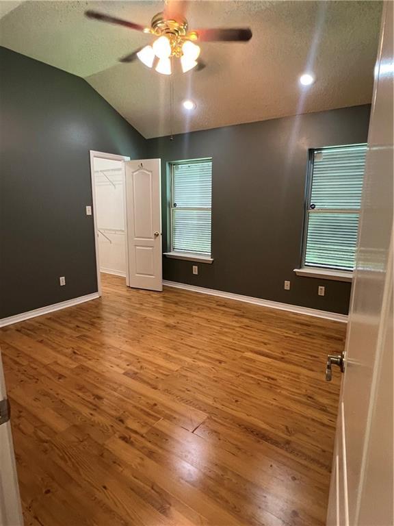 2712 Bayou Bleu Dr, Marrero, LA 70072 - unfurnished bedroom featuring wood finished floors, vaulted ceiling, a textured ceiling, a ceiling fan, and recessed lighting