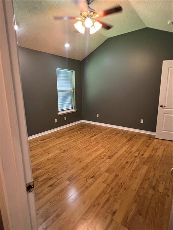 2712 Bayou Bleu Dr, Marrero, LA 70072 - spare room featuring a ceiling fan, lofted ceiling, wood finished floors, and a textured ceiling