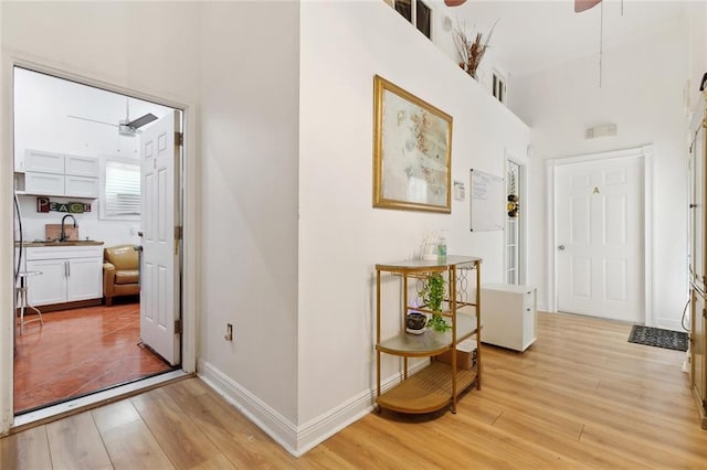 1801 Adams St, New Orleans, LA 70118 - foyer featuring ceiling fan, light wood-type flooring, and a towering ceiling