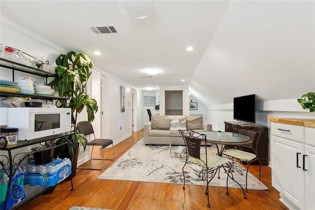 1801 Adams St, New Orleans, LA 70118 - living area with crown molding, wood finished floors, vaulted ceiling, and recessed lighting