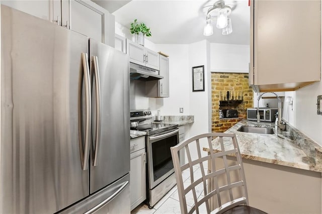 1801 Adams St, New Orleans, LA 70118 - kitchen with stainless steel appliances, under cabinet range hood, and light stone counters