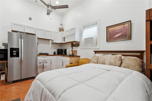 1801 Adams St, New Orleans, LA 70118 - bedroom featuring stainless steel fridge with ice dispenser, a towering ceiling, and light tile patterned flooring