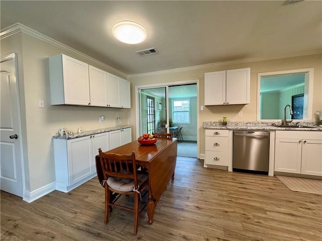 137 Diane Ave, River Ridge, LA 70123 - kitchen with stainless steel dishwasher, wood finished floors, ornamental molding, white cabinetry, and light stone counters