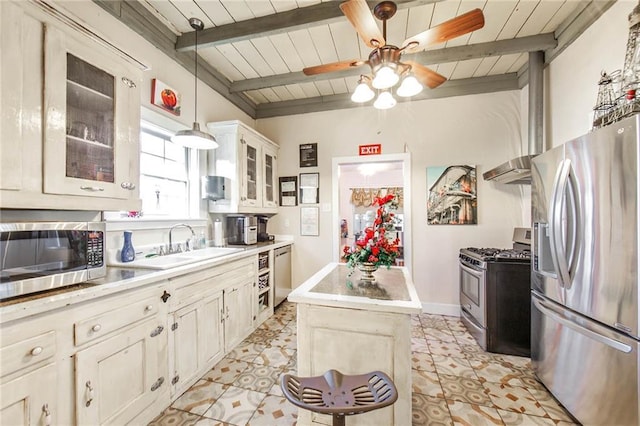 130 New Orleans Blvd, Houma, LA 70364 - kitchen with stainless steel appliances, ceiling fan, a wood ceiling with exposed beams, light countertops, and a center island