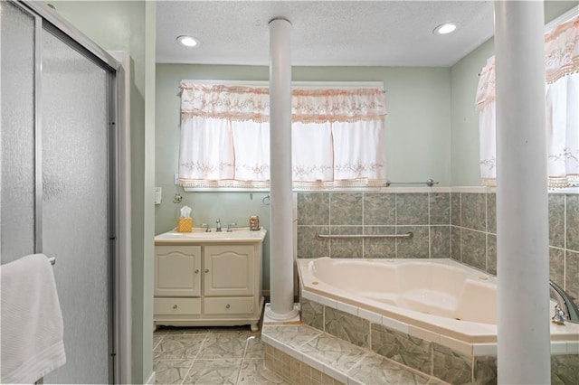 2936 General Ogden St, New Orleans, LA 70118 - bathroom with a bath, vanity, a shower stall, recessed lighting, and a textured ceiling