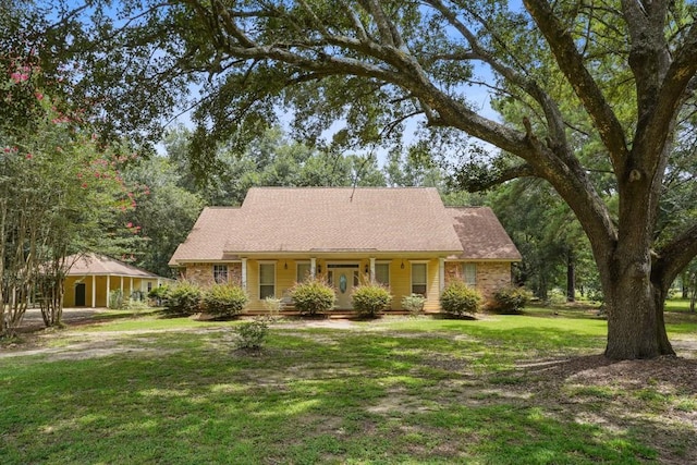 16233 Cody Ln, Covington, LA 70435 - view of front facade with a porch and a front lawn