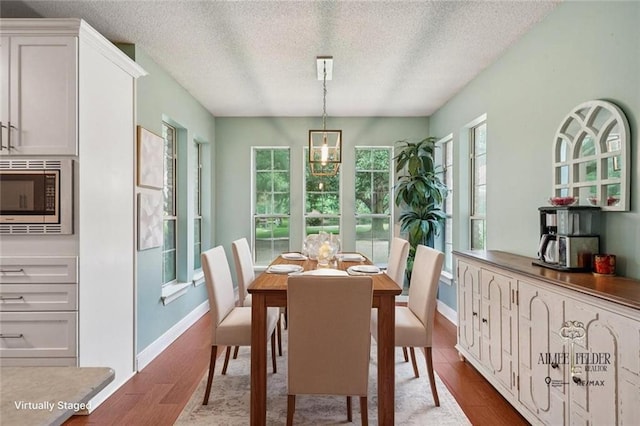 16233 Cody Ln, Covington, LA 70435 - dining room with wood finished floors and a textured ceiling
