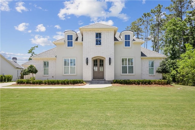 128 Juniper Ct, Mandeville, LA 70471 - french country style house with a front yard and a shingled roof