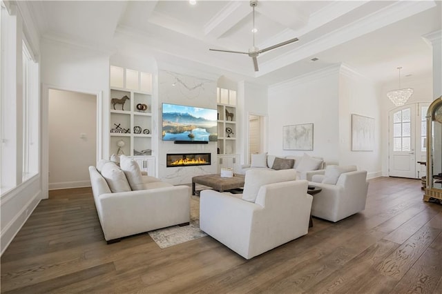 128 Juniper Ct, Mandeville, LA 70471 - living room with dark wood-style flooring, a glass covered fireplace, ornamental molding, coffered ceiling, and built in shelves