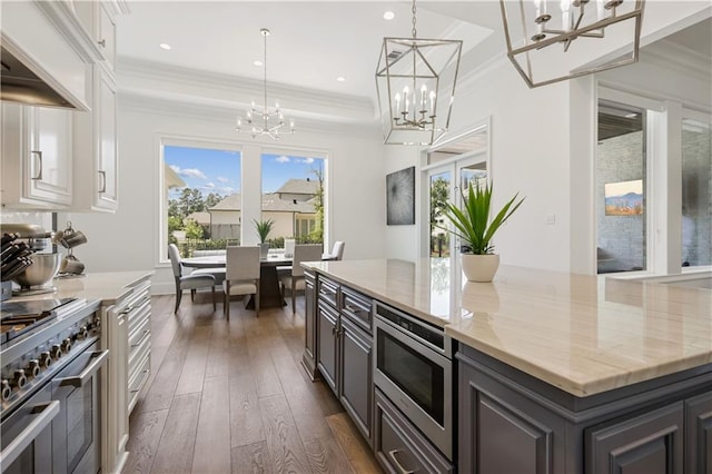 128 Juniper Ct, Mandeville, LA 70471 - kitchen with a chandelier, stainless steel appliances, premium range hood, dark wood-style flooring, and white cabinetry