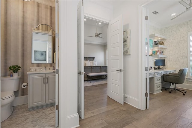 128 Juniper Ct, Mandeville, LA 70471 - bathroom with a ceiling fan, vanity, wood finished floors, ensuite bath, and ornamental molding