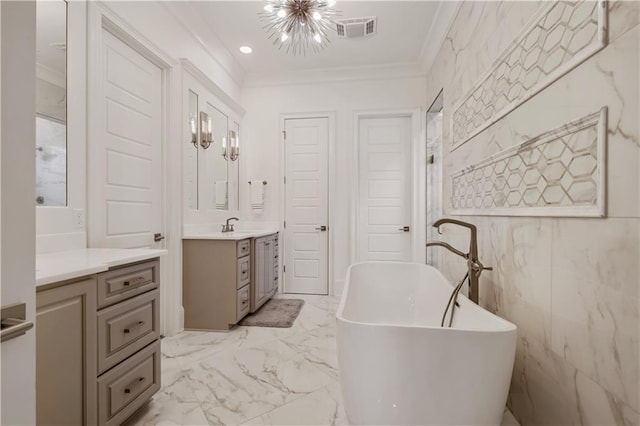 128 Juniper Ct, Mandeville, LA 70471 - full bathroom featuring vanity, a freestanding tub, crown molding, marble finish floors, and a chandelier