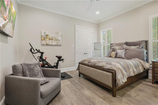 128 Juniper Ct, Mandeville, LA 70471 - bedroom with light wood finished floors, crown molding, recessed lighting, and a ceiling fan